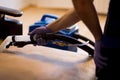 The master does a dry cleaning of the upholstery of a soft sofa using a professional washing vacuum cleaner. process photo Royalty Free Stock Photo