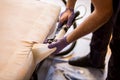 The master does a dry cleaning of the upholstery of a soft sofa using a professional washing vacuum cleaner. process photo Royalty Free Stock Photo