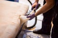 The master does a dry cleaning of the upholstery of a soft sofa using a professional washing vacuum cleaner. process photo Royalty Free Stock Photo