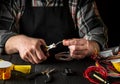 Master electrician cuts the wire with diagonal pliers. Working environment on workshop table