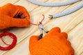 Master electrician with pliers cuts a red wire on a working wooden table Royalty Free Stock Photo