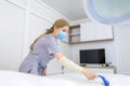 The master of electrolysis prepares the couch before the procedure for removing unwanted hair Royalty Free Stock Photo
