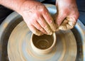 The master forms a clay cup on a potter`s wheel Royalty Free Stock Photo