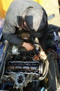 The master in the garage taps the valves in the old car, VAZ car, an old worn-out car