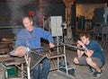 The master glass blower gets assistance