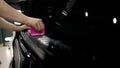 Detailing the car. The technician installs vinyl to protect the boot area of the trunk. The master glues the film in the