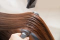 Master hairdresser blow dry client of young woman in spa beauty salon Royalty Free Stock Photo