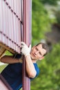 Master holds a pipe for the roof, repairs