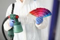 Master holds spray gun and color palette in crayfish. Royalty Free Stock Photo