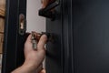 The master installs the core for the door lock, installation work with the door. Royalty Free Stock Photo