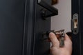 The master installs the core for the door lock, installation work with the door. Royalty Free Stock Photo