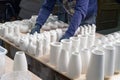 The master lays out Finished plaster products on the table: vases, figurines, bowls. Making and casting in the workshop decorative