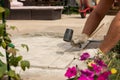 The master lays paving stones in layers. Garden brick pathway paving. Laying concrete paving slabs in house courtyard on sand Royalty Free Stock Photo