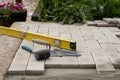 The master lays paving stones in layers. Garden brick pathway paving. Laying concrete paving slabs in house courtyard on sand Royalty Free Stock Photo