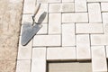 The master lays paving stones in layers. Garden brick pathway paving. Laying concrete paving slabs in house courtyard on sand Royalty Free Stock Photo
