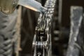 Master lubricates a bicycle chain on a bicycle