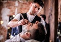 Master makes beards correction in barbershop salon. Close up photo.