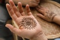 Master making henna tattoo, focus on hand. Traditional mehndi Royalty Free Stock Photo