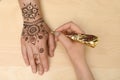 Master making henna tattoo on hand, top view. Traditional mehndi Royalty Free Stock Photo