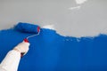 Master painter paints wall bright blue closeup Royalty Free Stock Photo