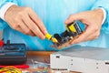 Master parses electronic hardware for repair in service workshop Royalty Free Stock Photo
