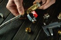 Master plumber connects brass fittings to a plumbing faucet. Installation of gas equipment. Close-up of a master hands while Royalty Free Stock Photo