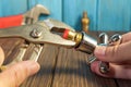 The master plumber repairs the tap with a wrench, the working environment in the workshop
