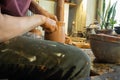 A master potter in an old craft workshop professionally forms a pot of clay with his hands Royalty Free Stock Photo