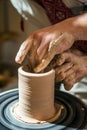 Master potter teaches the child how to make a jug out of clay