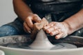 Master on potter wheel makes clay dishes. Workshop place Royalty Free Stock Photo