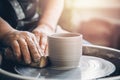 Master on potter wheel makes clay dishes. Workshop place Royalty Free Stock Photo