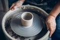 Master on potter wheel makes clay dishes. Workshop place Royalty Free Stock Photo