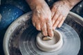 Master on potter wheel makes clay dishes. Workshop place Royalty Free Stock Photo