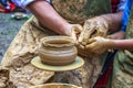 A master of pottery craftsmanship teaches a child. Pottery master class