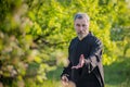 A master practices tai chi in a wild garden Royalty Free Stock Photo