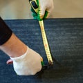 The master prepares a bituminous tape for installation, protection of a floor against moisture. Royalty Free Stock Photo