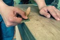 The master processes the edge of the furniture with a working knife