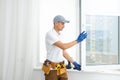 master puts a new double-glazed window in a plastic window