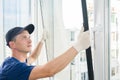 Master puts a new double-glazed window in a plastic window