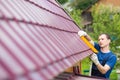 Master on repair of roofs makes measurements tool Royalty Free Stock Photo