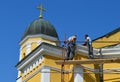 Master repairs the roof of the church