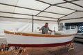 master repairs a wooden boat in Rovinj, Croatia, August 30, 2018,. Workshop for the restoration of ships on the shores