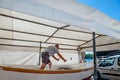 master repairs a wooden boat in Rovinj, Croatia, August 30, 2018,. Workshop for the restoration of ships on the shores