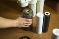 The master replaces dirty filters in the home water purification system. Human hands, filter, membrane Royalty Free Stock Photo