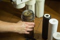 The master replaces dirty filters in the home water purification system. Human hands, filter, membrane Royalty Free Stock Photo