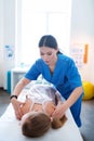 Concentrated dark-haired woman in blue uniform processing back