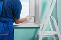 The masterÃ¢â¬â¢s hands in white gloves adjust the installed plastic windows with a key to properly fit the window into the frame Royalty Free Stock Photo