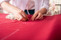 The master seamstress rocks two parts of the fabric with pins