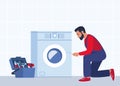 Master with set of professional tools repairs a washing machine. Washing machines repair service. Man character in uniform and
