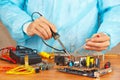 Master solder electronic components of device in service workshop Royalty Free Stock Photo
